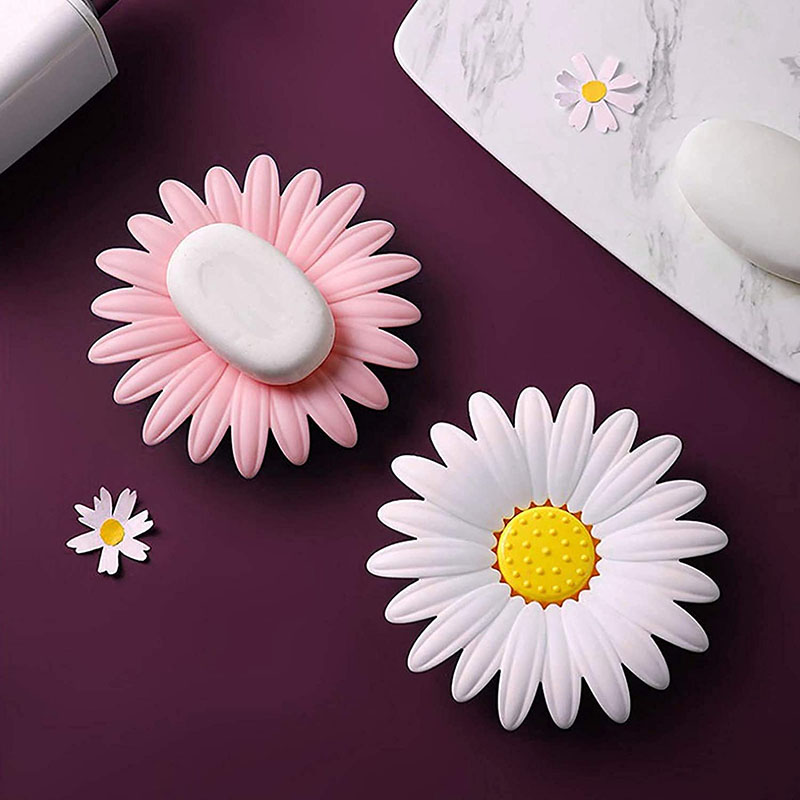 daisy flower plastic soap tray holding soap bar on bathroom sink counter