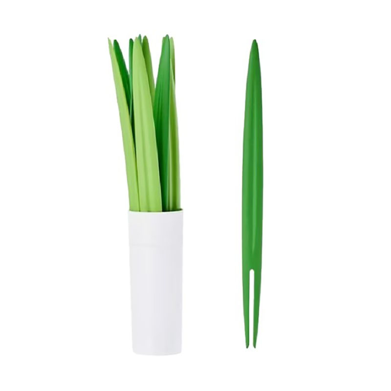 green grass leaf fruit fork set with white storage cylinder pure white background