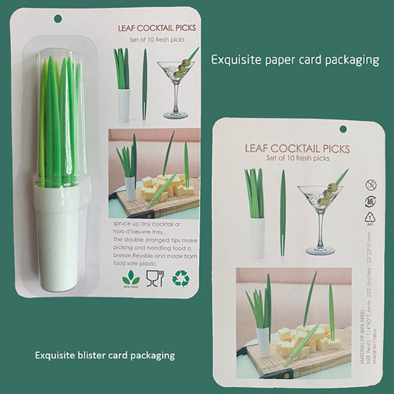 grass leaf forks arranged on wooden tea table with fruit plate