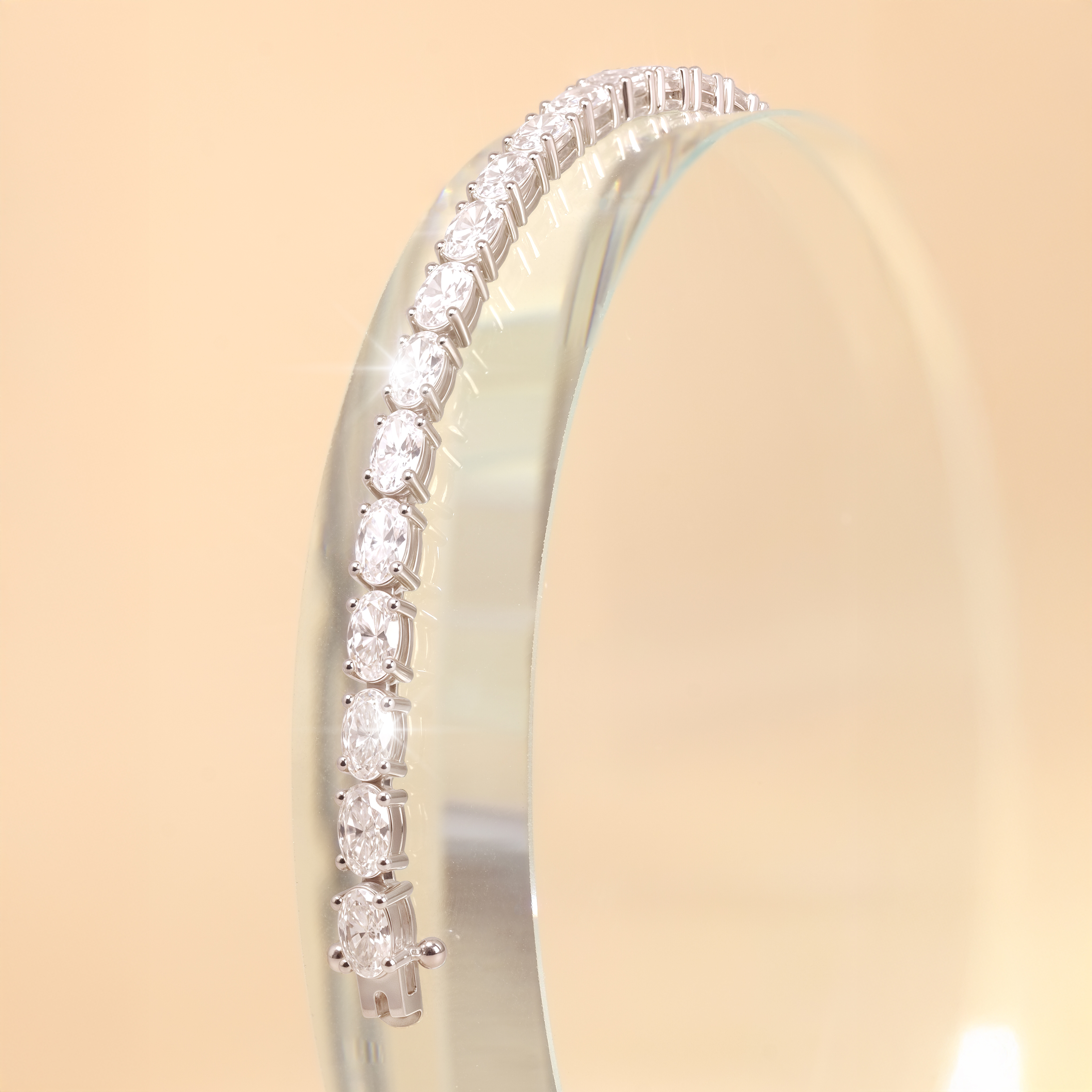Close up of oval shaped diamonds in 4-prong setting on tennis bracelet.