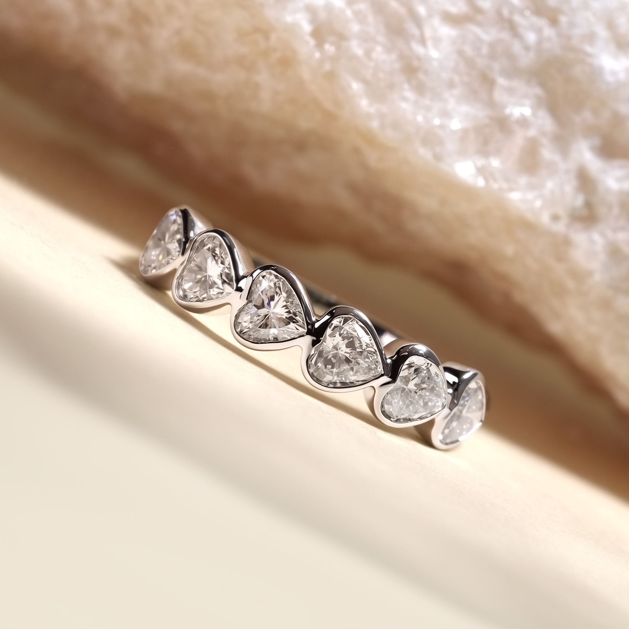Close up of PT950 platinum heart bezel eternity band showing DEF VVS lab grown diamonds