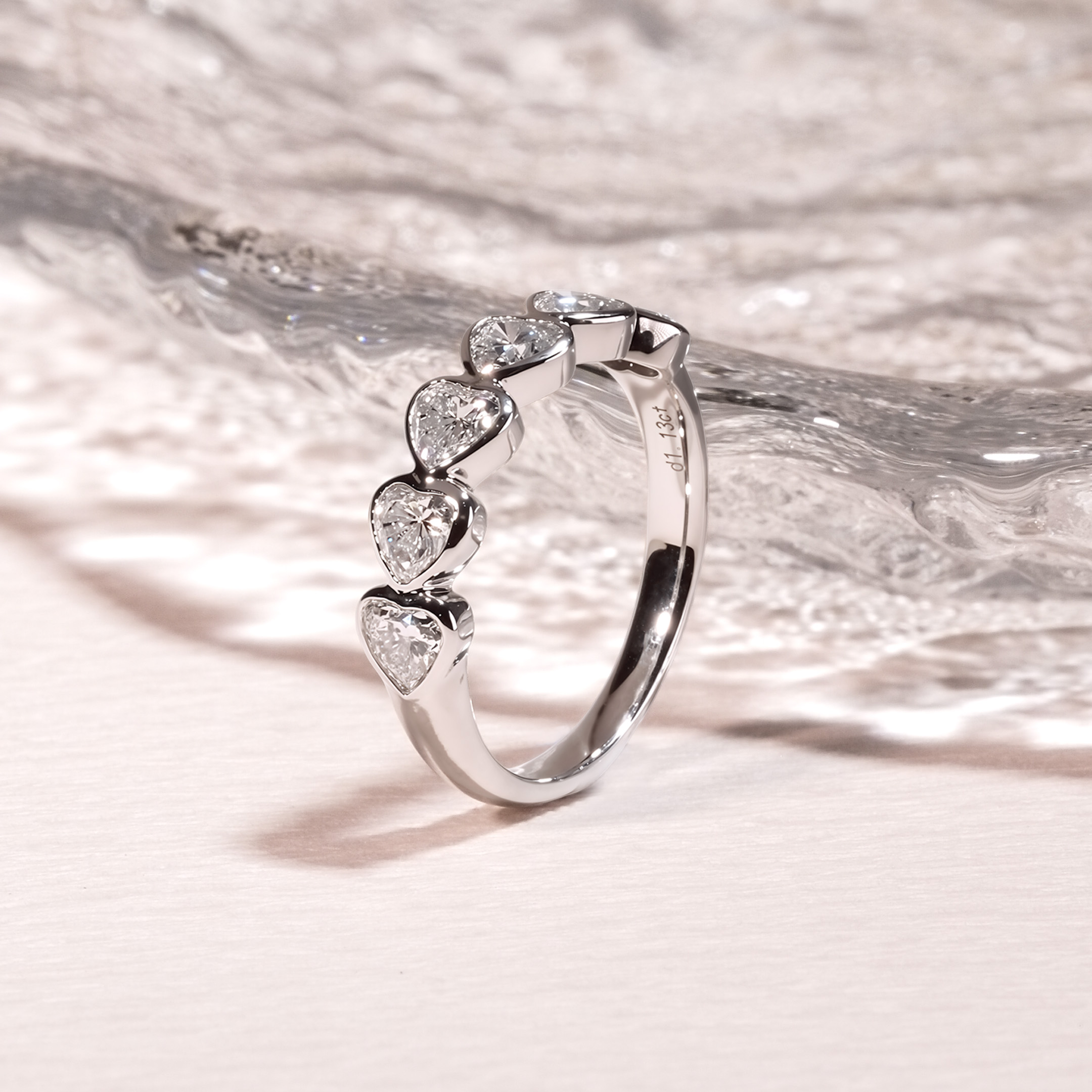 Close up of PT950 platinum heart bezel eternity band showing DEF VVS lab grown diamonds