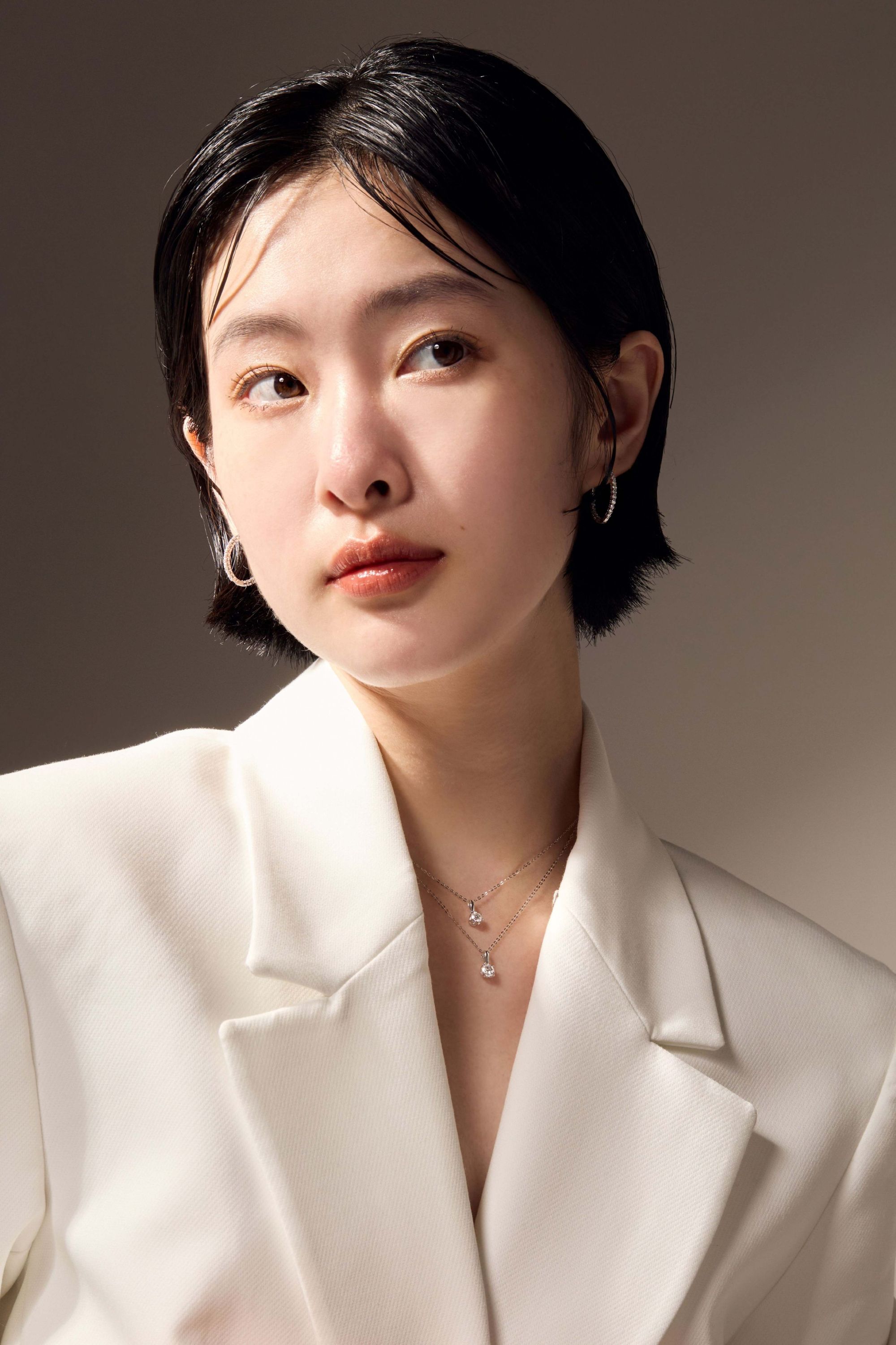 Model wearing elegant oval inside-out diamond earrings.