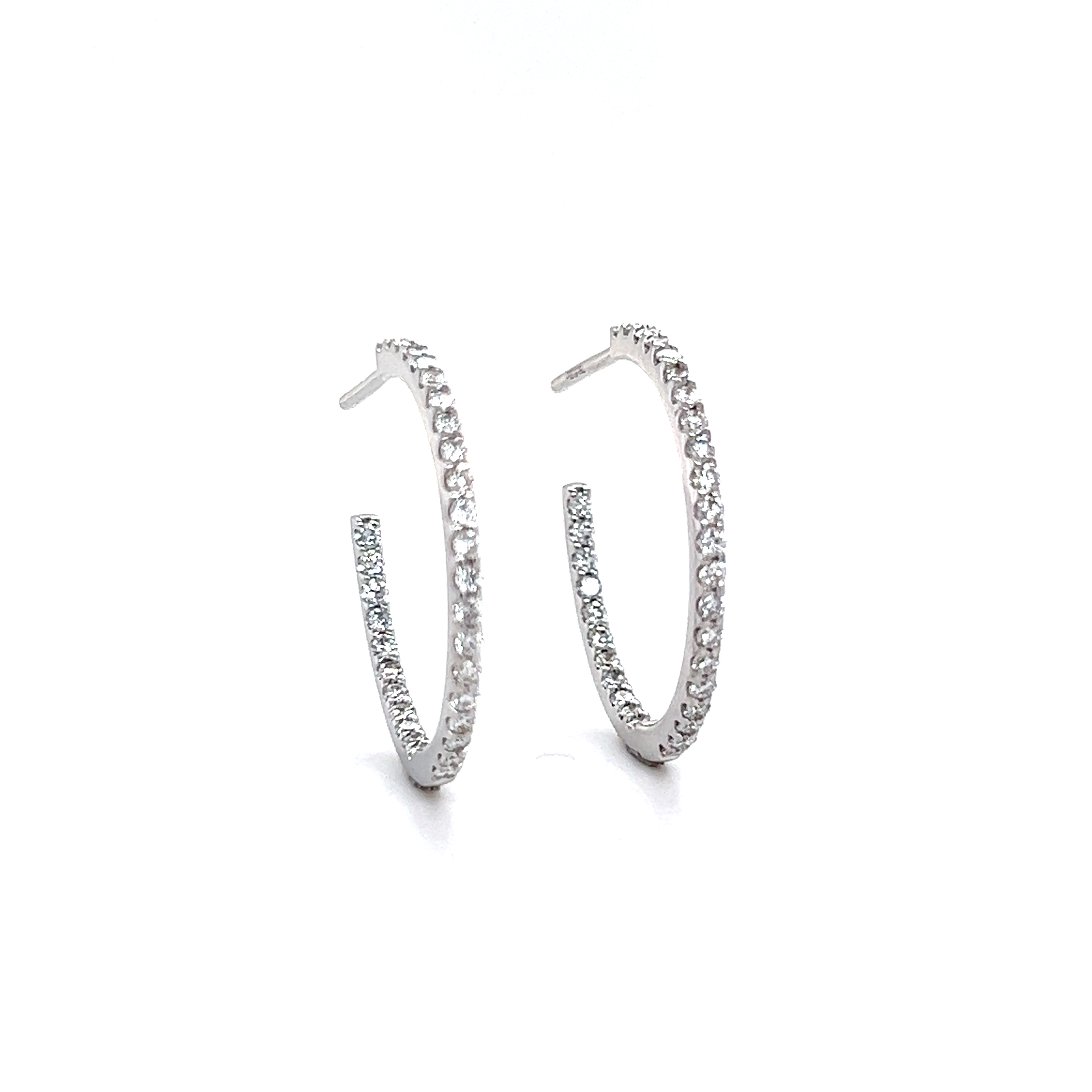 Side view of diamond hoop earrings showing inside-out setting technique.