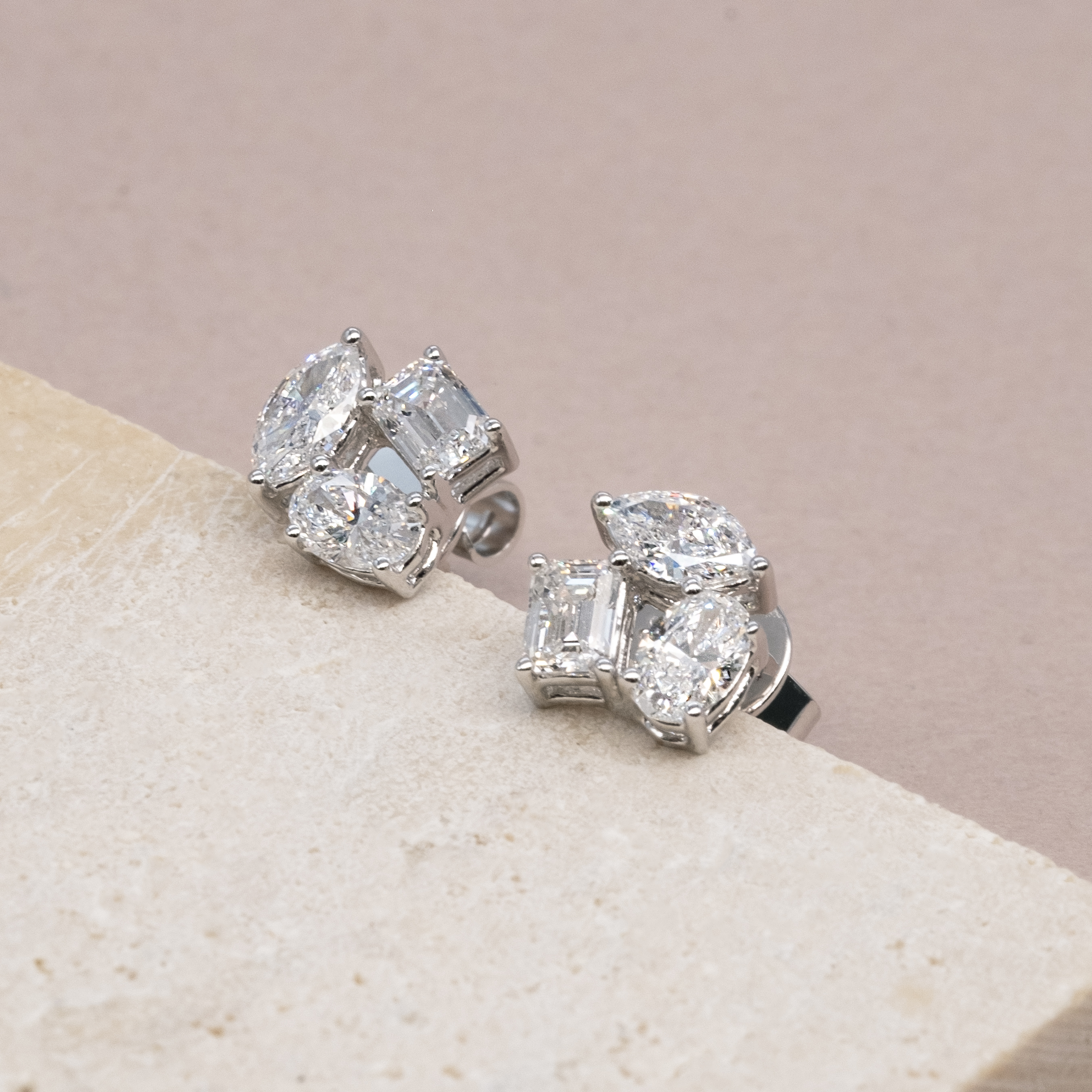 Side profile of 1.2ct geometric diamond earrings showing prong setting details.