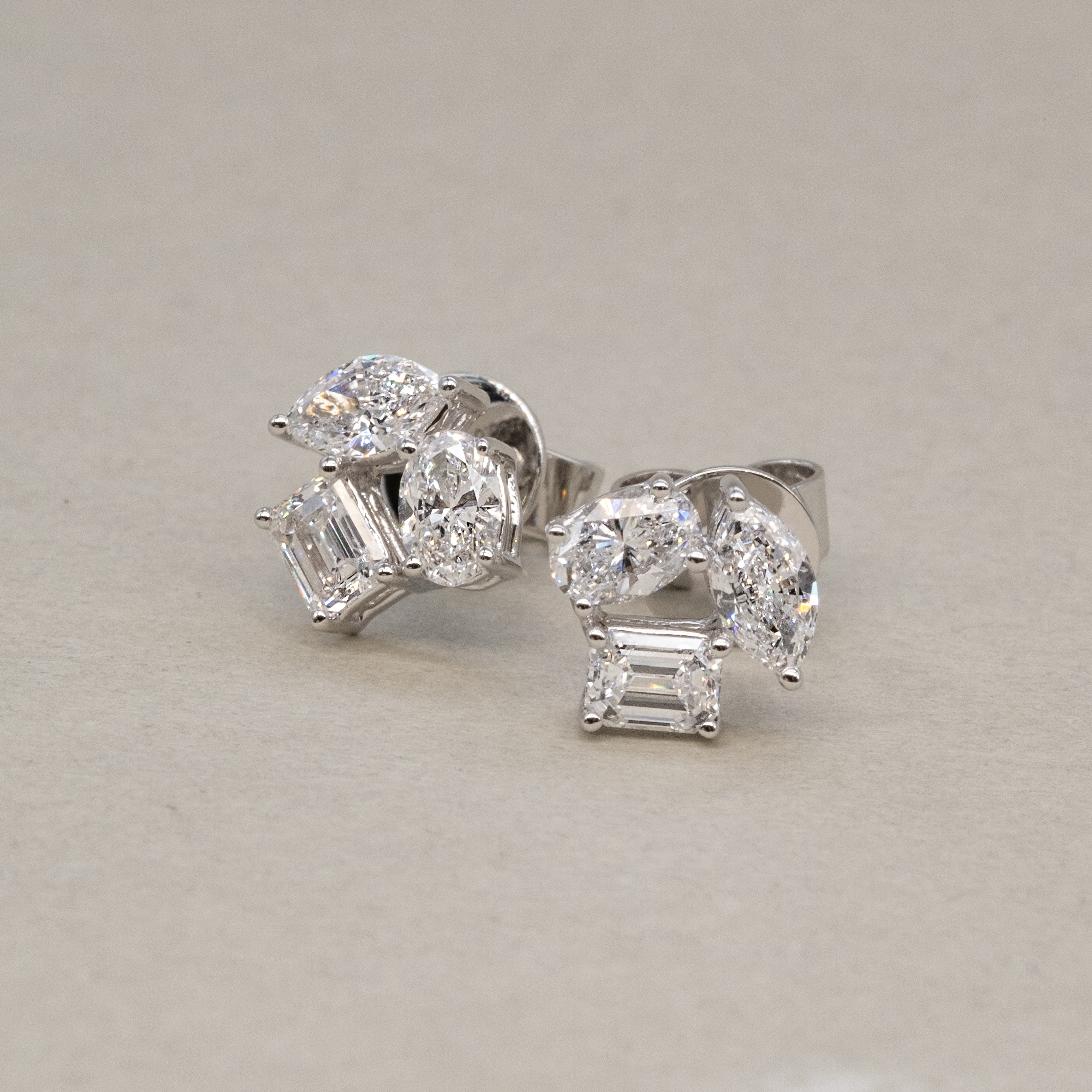 Side profile of 1.2ct geometric diamond earrings showing prong setting details.