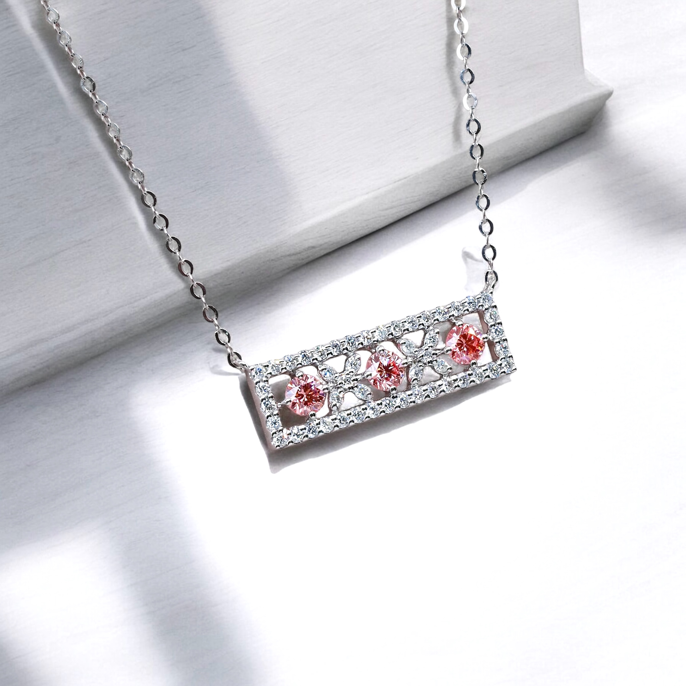Close up of pink diamond sakura necklace with halo frame design, total 0.58ct