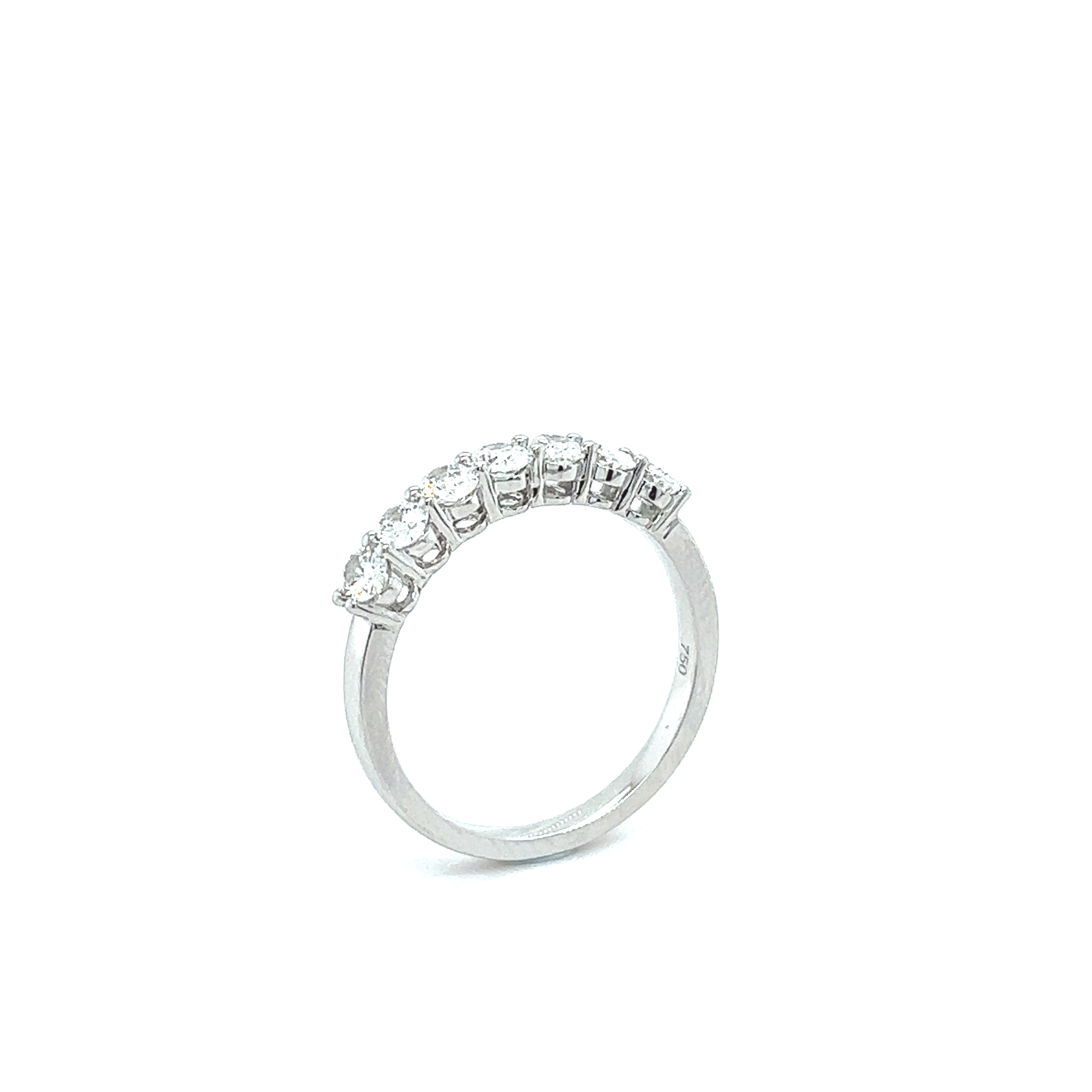 Side view of oval cut diamond anniversary band showing prong setting.
