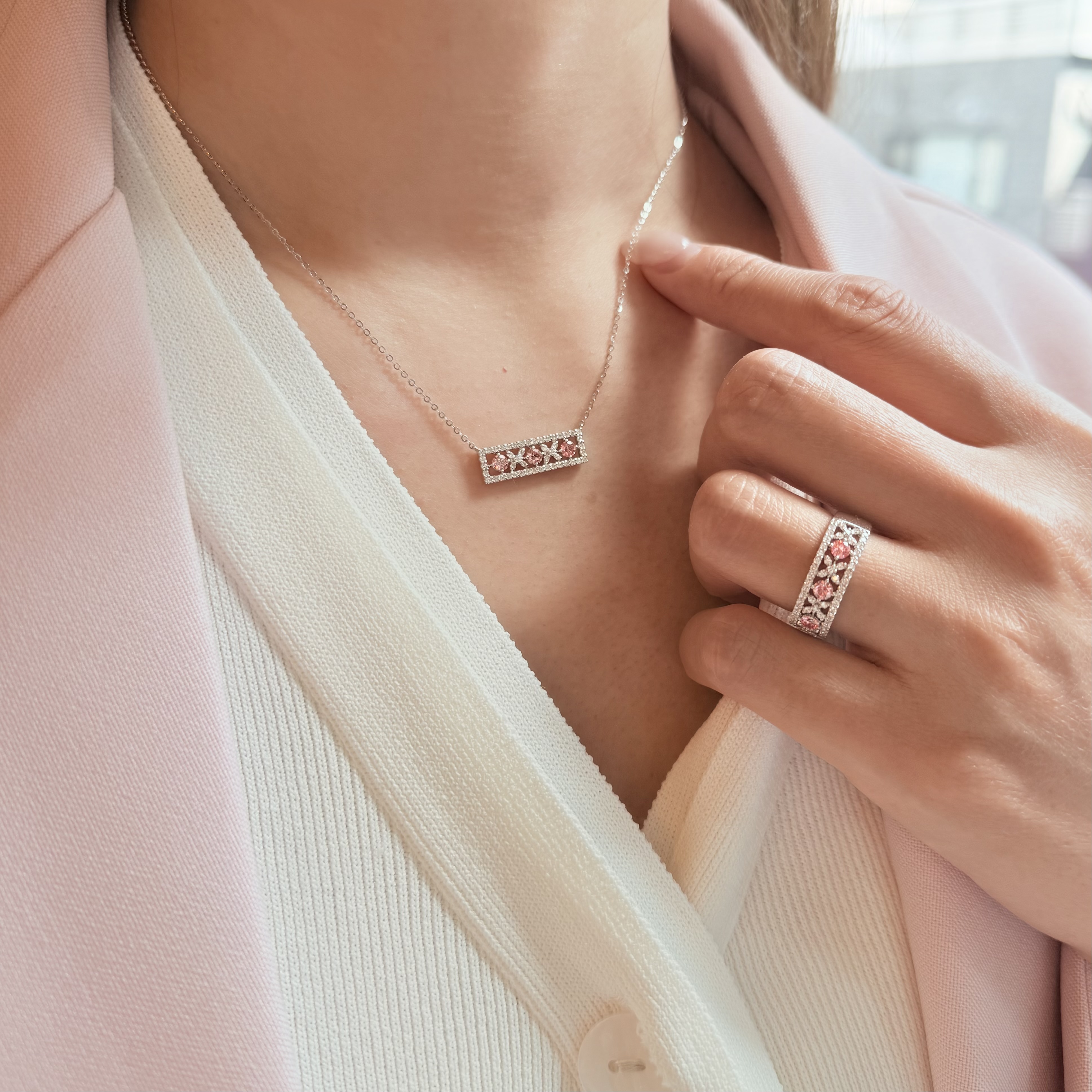 Woman wearing sakura pink lab grown diamond bar necklace in 18K white gold, lifestyle shot