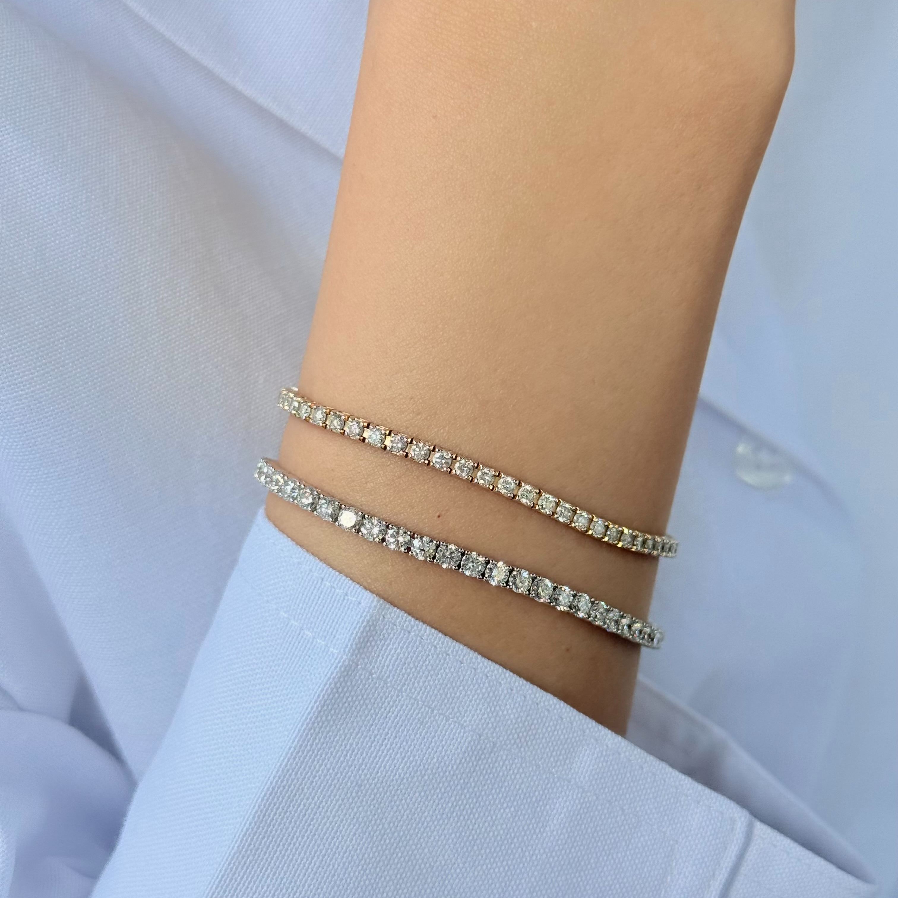 Woman wearing 2.3mm and 3.00mm classic diamond tennis bracelet in yellow gold and white gold stacked.
