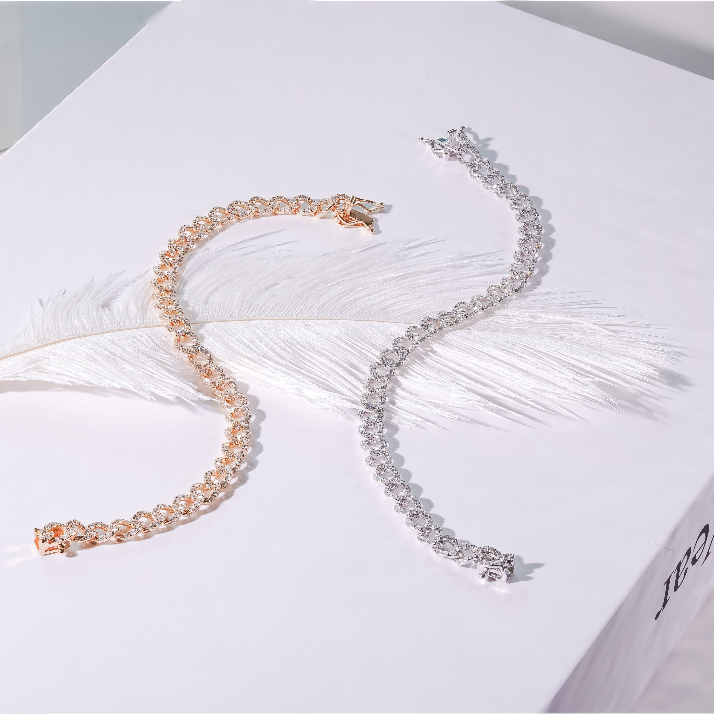 Starburst design diamond cuban link bracelets in rose gold and white gold.