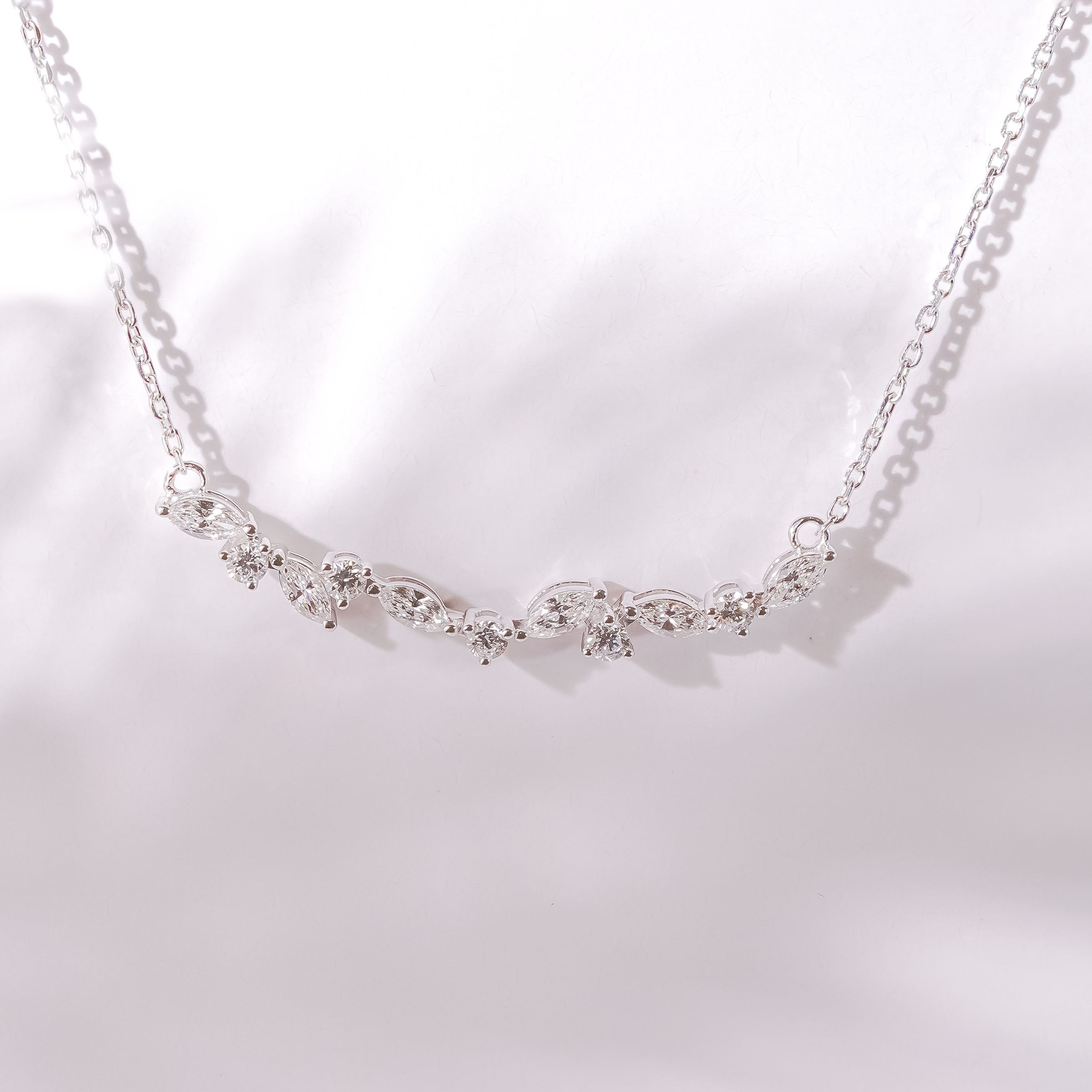 Close up of diamond vine necklace showing marquise and round cut stones, 0.61ctw.