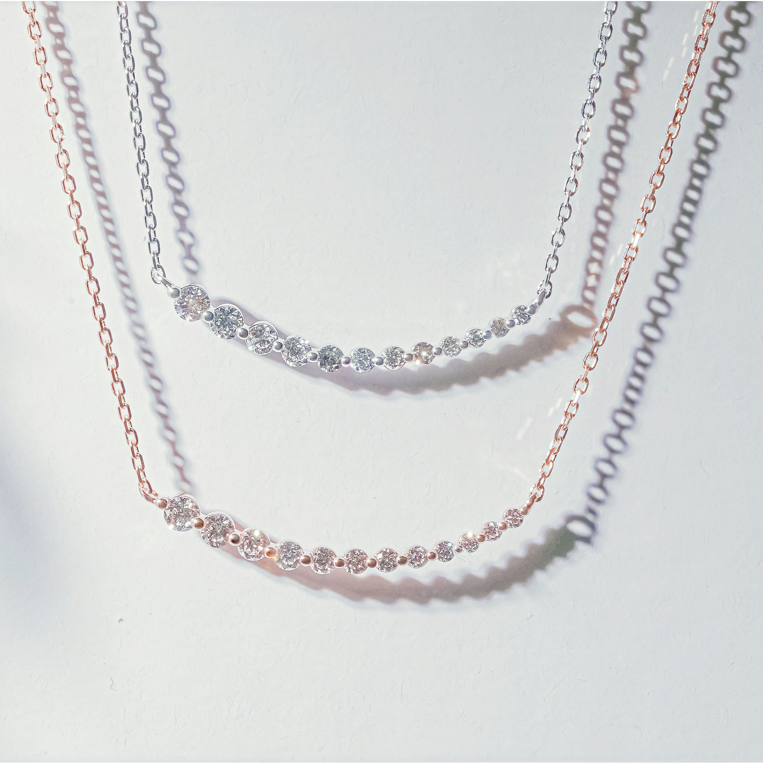 Dainty graduated diamond bar necklaces in white, and rose gold