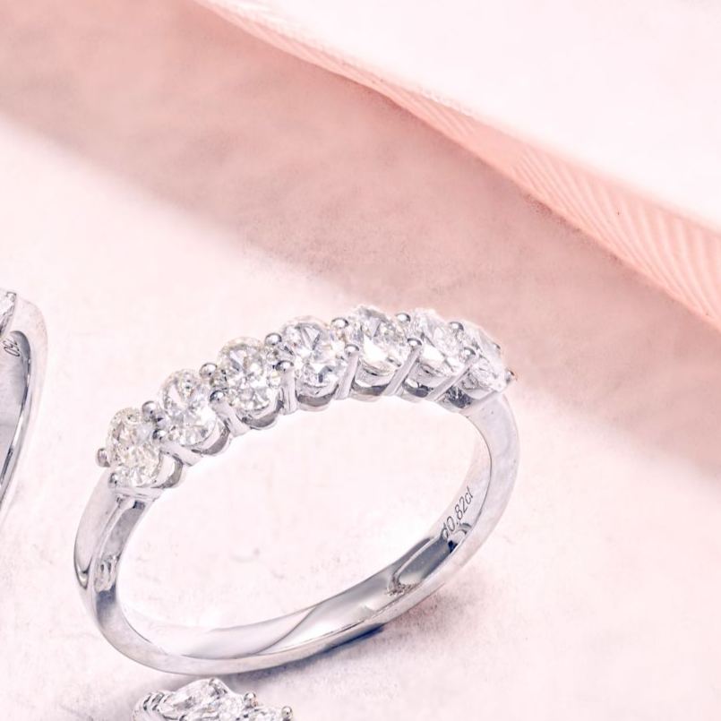 Close up of DEF VVS oval lab diamonds in a 7-stone ring setting.