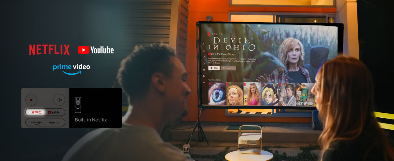 Couple watching Netflix and movies outdoors with the Elfin Flip projector.