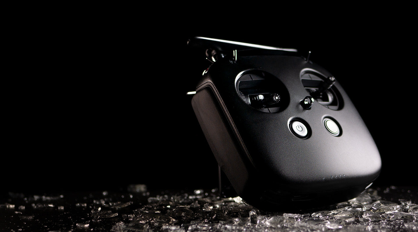 A DJI FPV Remote Controller against a dark background