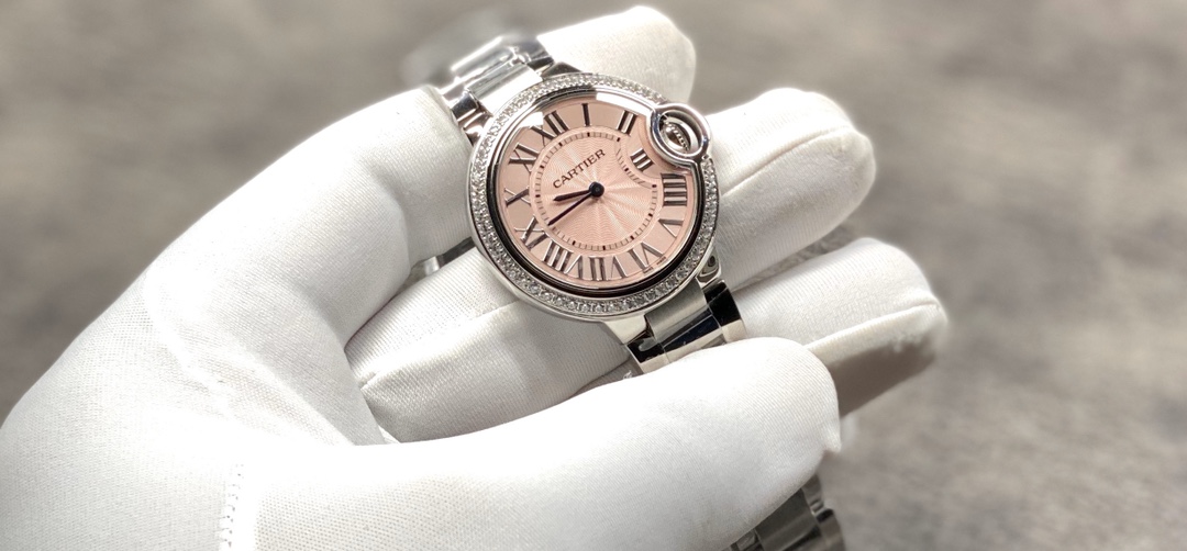 Cartier Ballon Bleu Collection! Model WE9003Z3, ladies' watch with a 33mm case diameter. The pink Ballon Bleu has always been a classic, and this version features a steel bracelet with diamond accents.