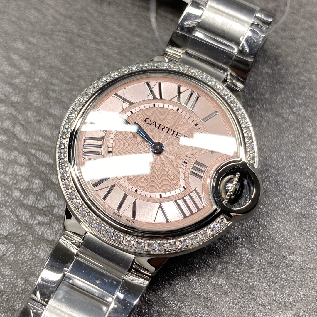 Cartier Ballon Bleu Collection! Model WE9003Z3, ladies' watch with a 33mm case diameter. The pink Ballon Bleu has always been a classic, and this version features a steel bracelet with diamond accents.