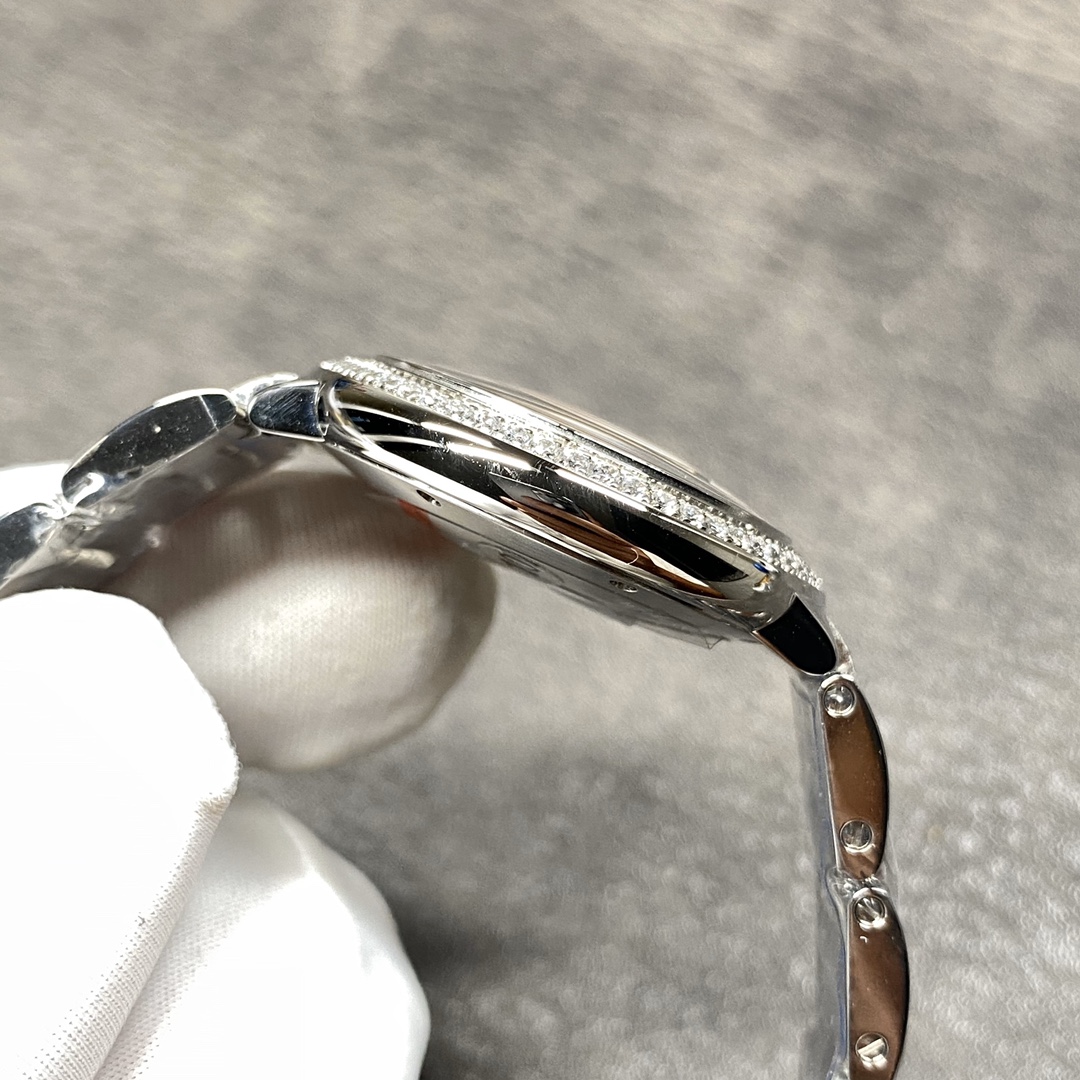 Cartier Ballon Bleu Collection! Model WE9003Z3, ladies' watch with a 33mm case diameter. The pink Ballon Bleu has always been a classic, and this version features a steel bracelet with diamond accents.