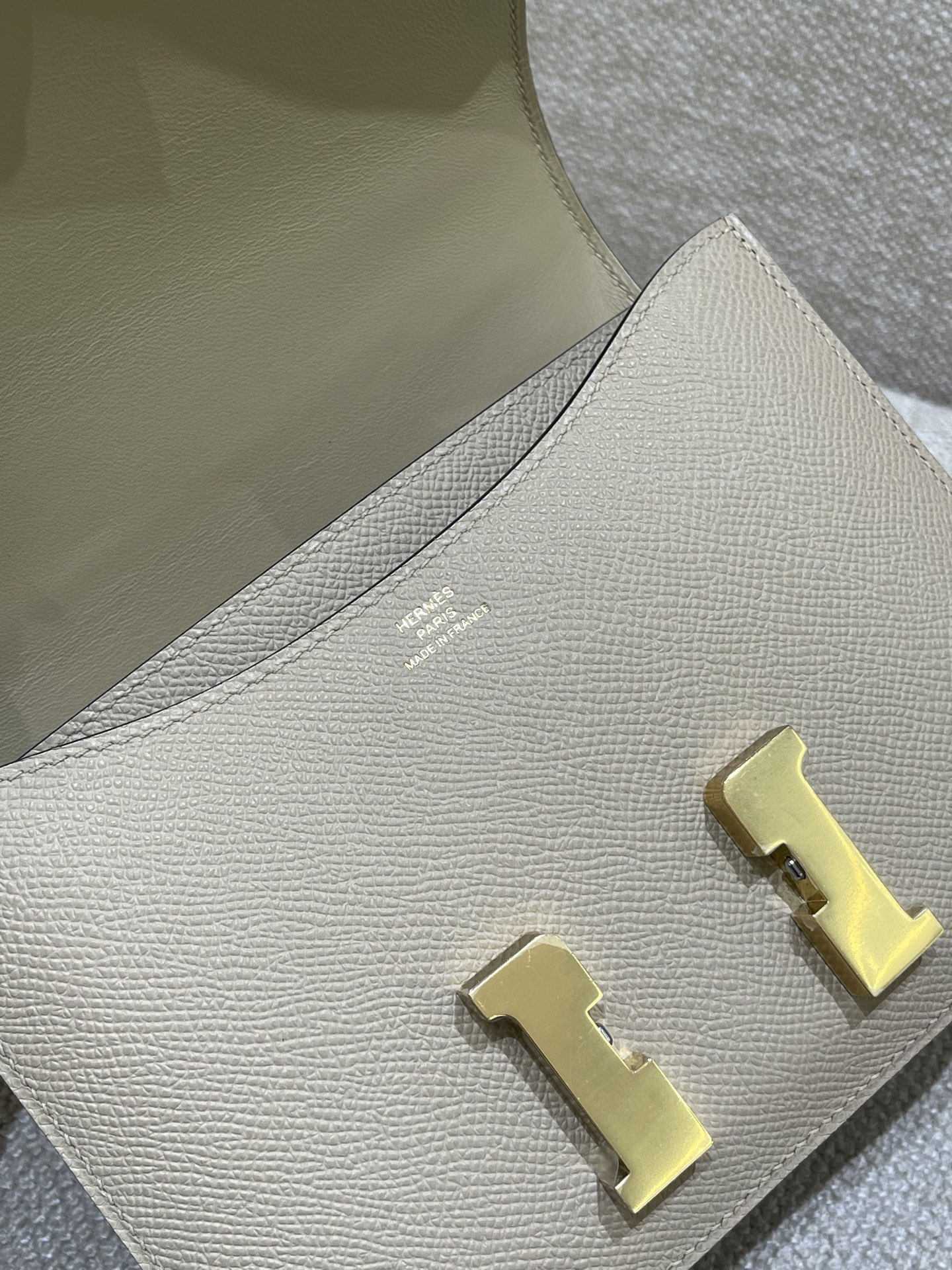 Hermès Model: Constance 19 Color: Trench Gray with Gold Hardware Dimensions: 19cm x 15cm x 4cm