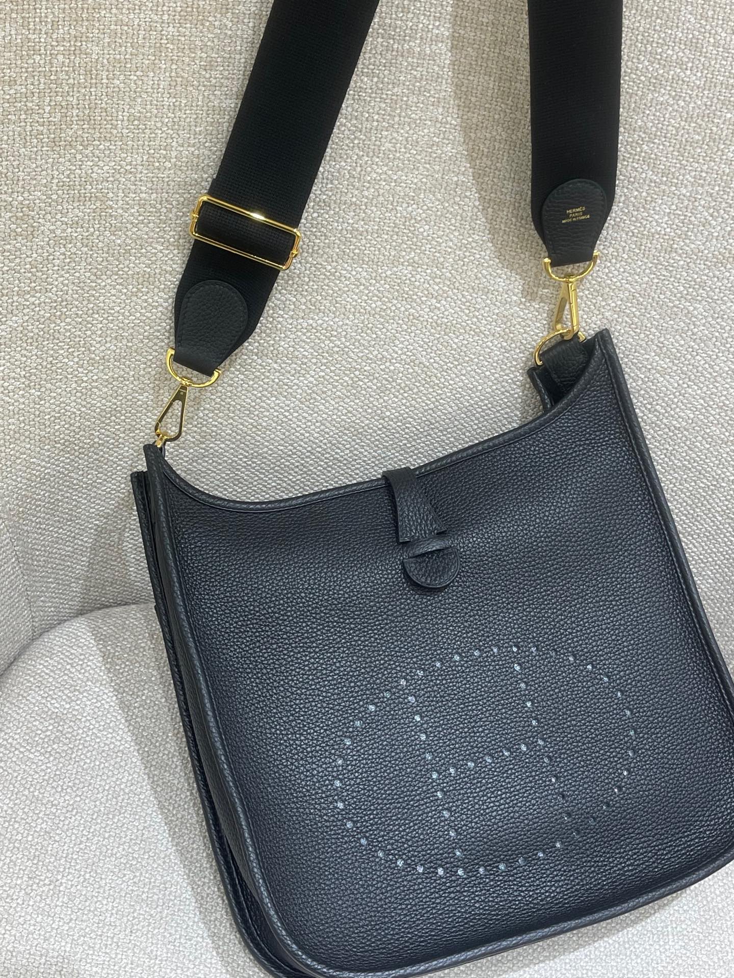 Hermès Model: Mini Evelyne Color: Black with Gold Hardware Dimensions: 29cm x 30cm x 9cm