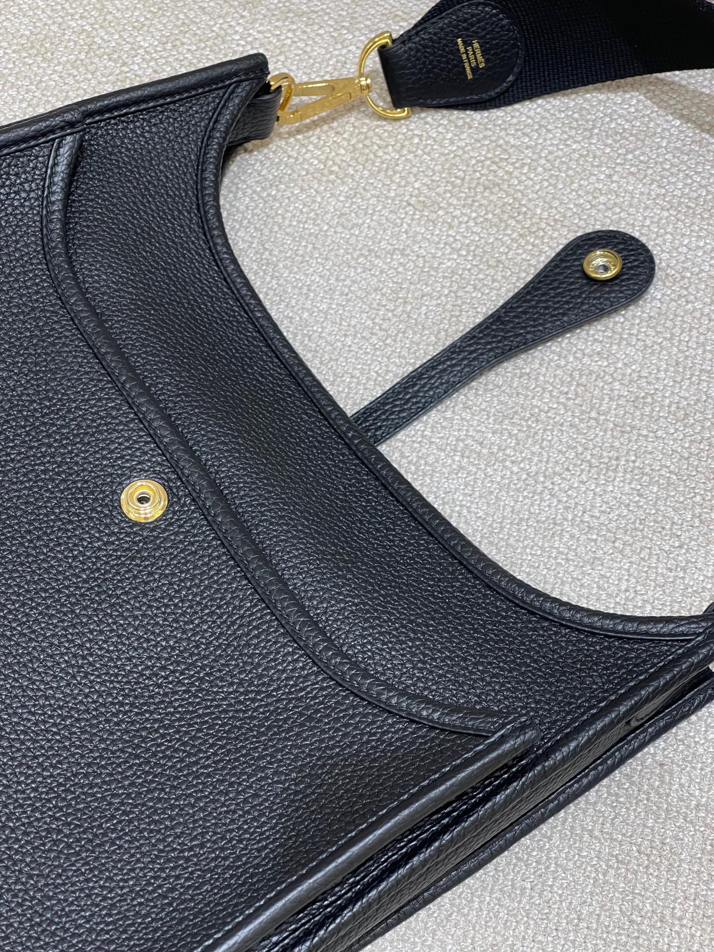 Hermès Model: Mini Evelyne Color: Black with Gold Hardware Dimensions: 29cm x 30cm x 9cm