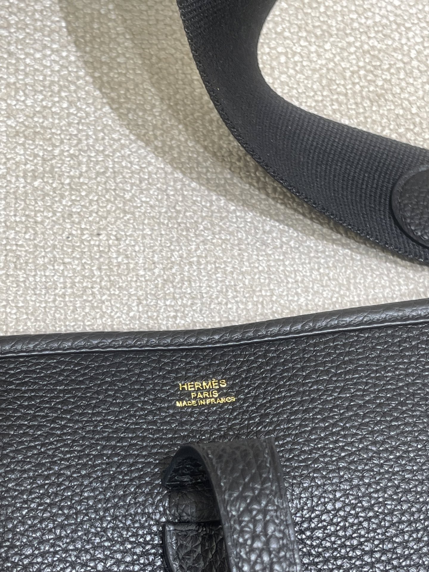 Hermès Model: Mini Evelyne Color: Black with Gold Hardware Dimensions: 29cm x 30cm x 9cm