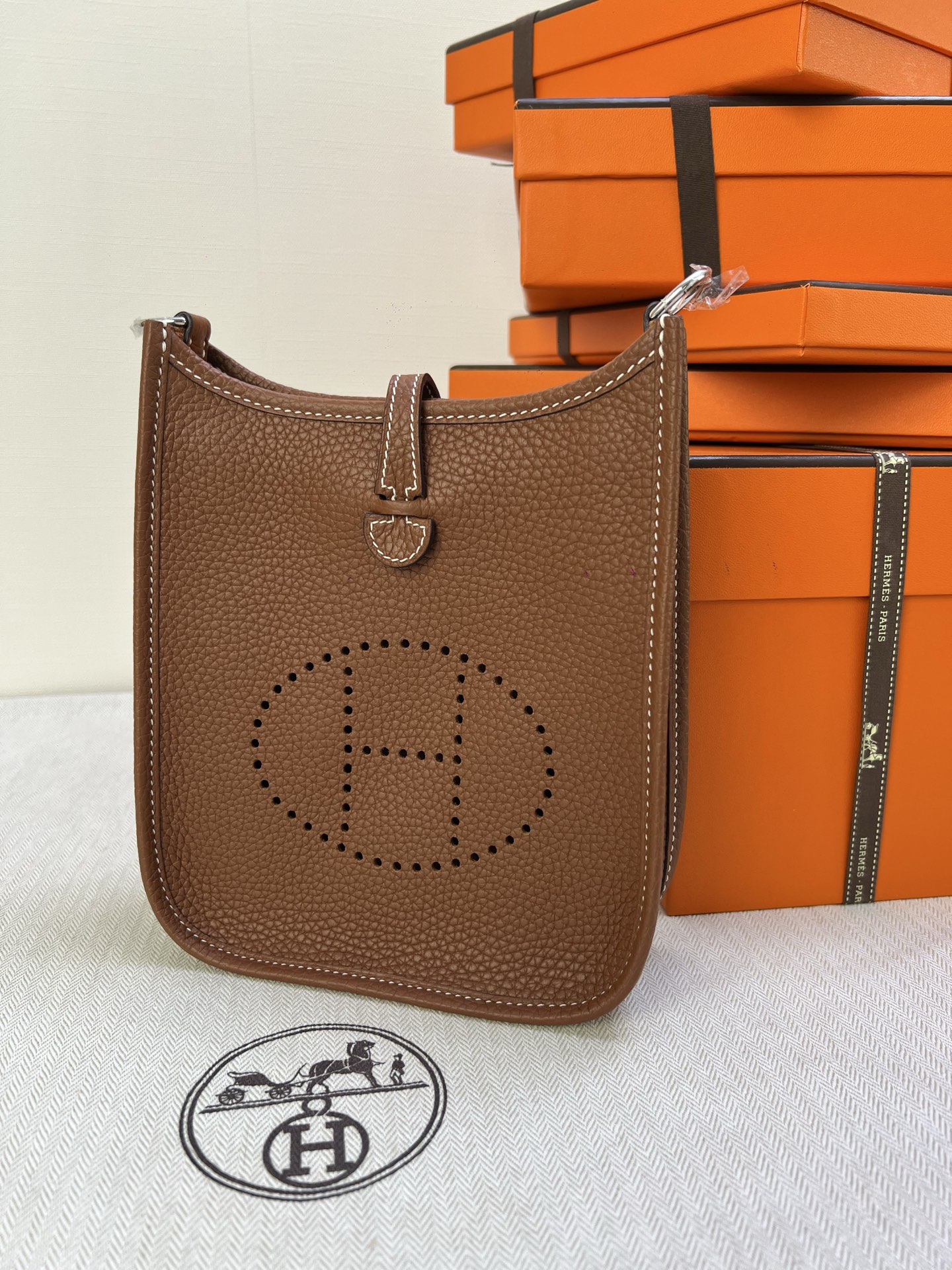 Hermès Model: Mini Evelyne Color: Golden Brown with Silver Buckle Dimensions: 16cm x 18cm x 5cm