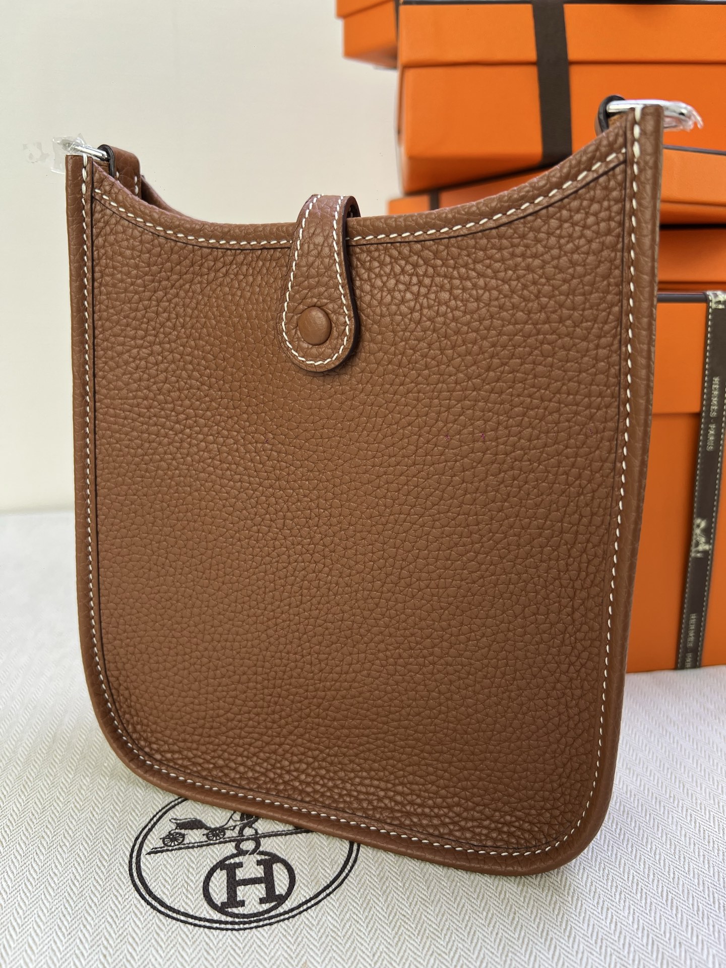 Hermès Model: Mini Evelyne Color: Golden Brown with Silver Buckle Dimensions: 16cm x 18cm x 5cm