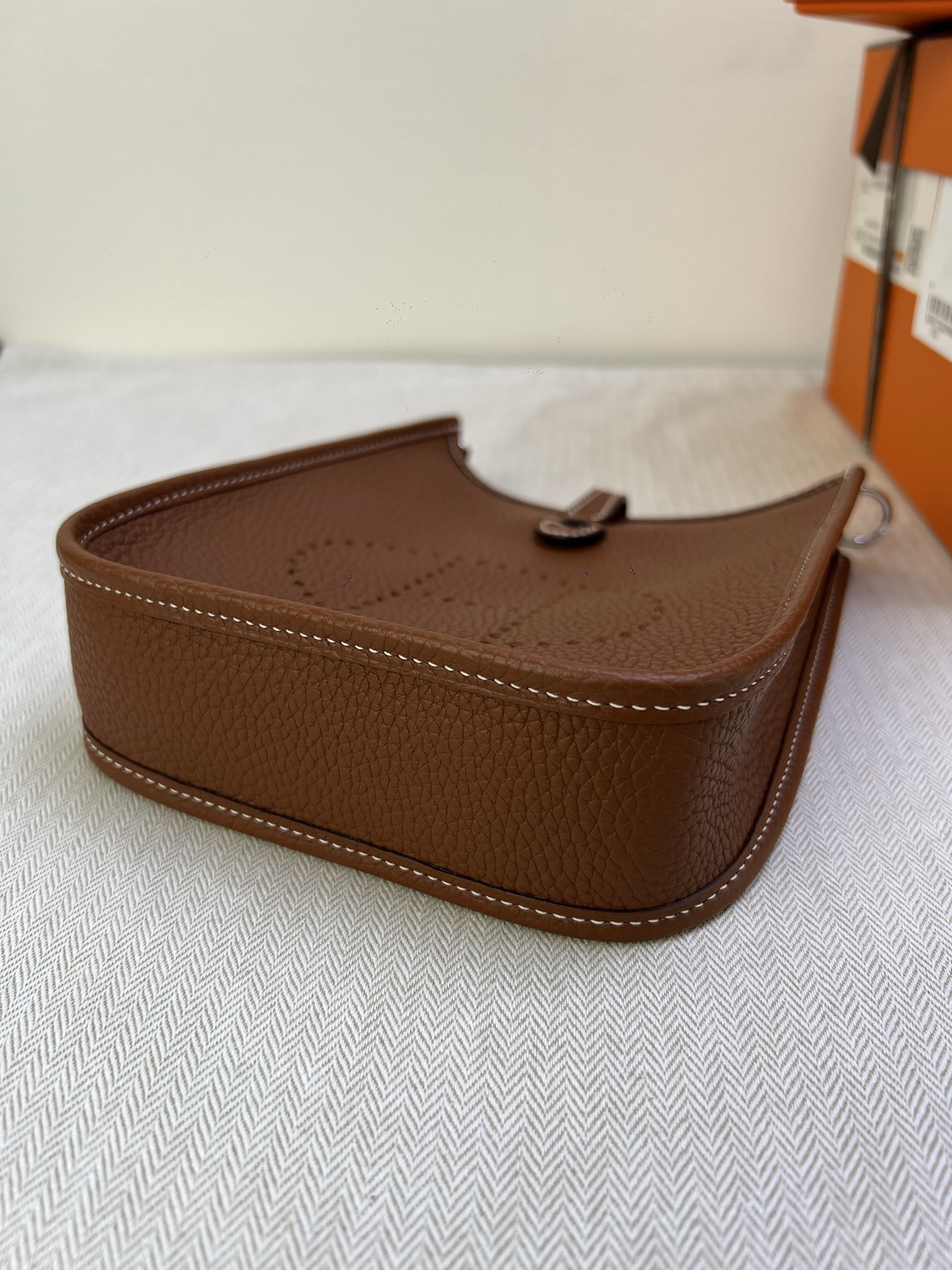 Hermès Model: Mini Evelyne Color: Golden Brown with Silver Buckle Dimensions: 16cm x 18cm x 5cm