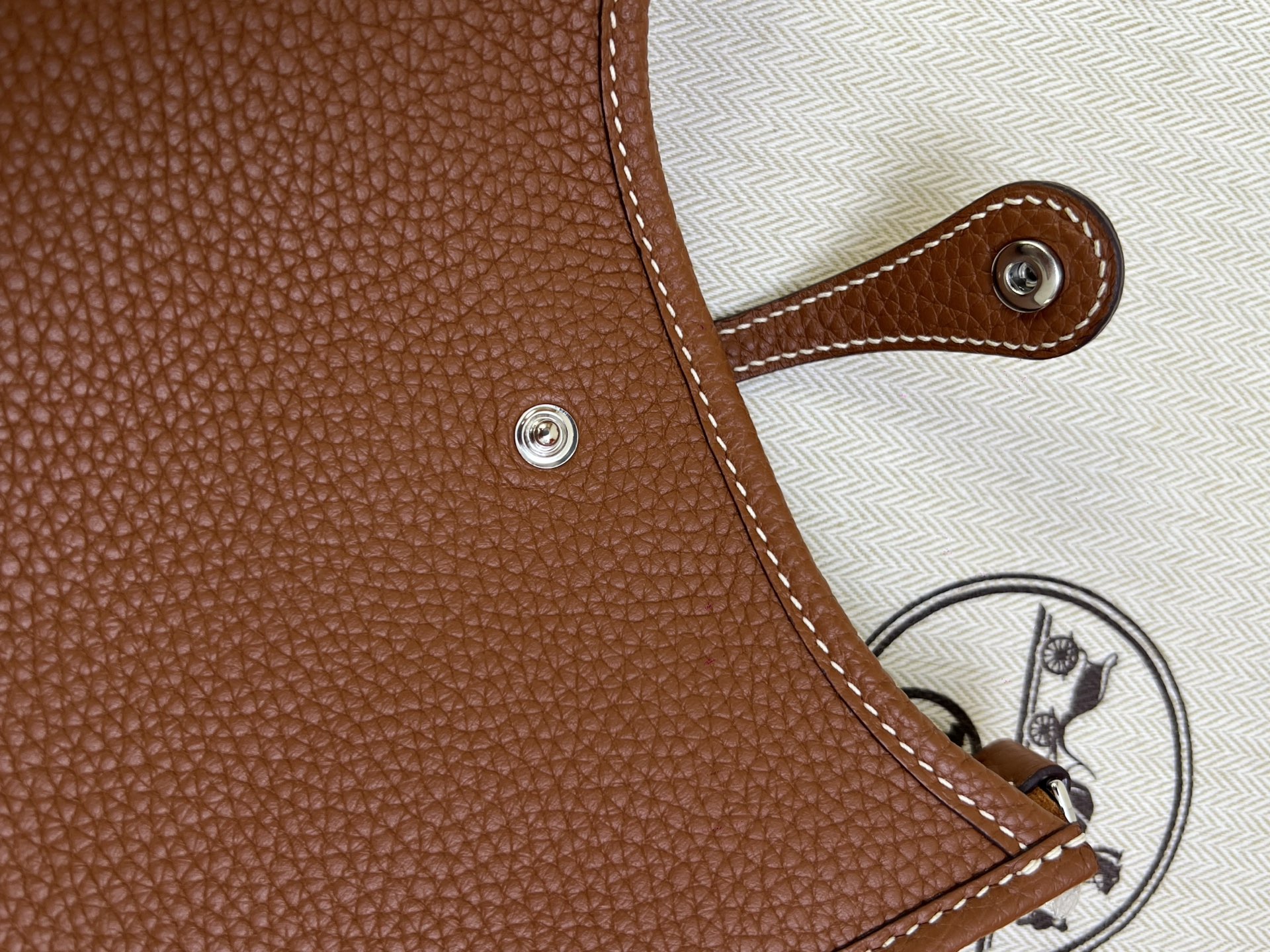 Hermès Model: Mini Evelyne Color: Golden Brown with Silver Buckle Dimensions: 16cm x 18cm x 5cm