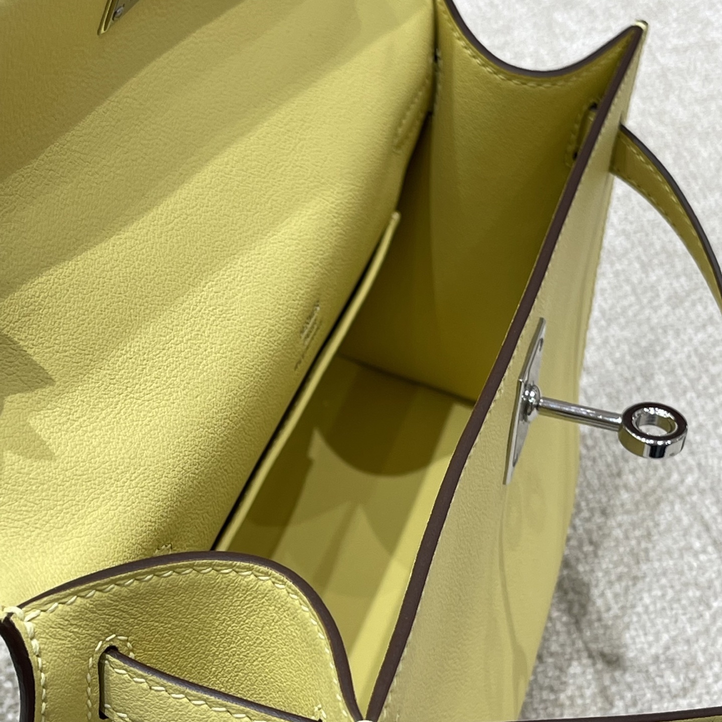 Hermès Model: Kelly Mini First Generation Color: Chick Yellow with Silver Hardware Dimensions: 22cm x 14cm x 7cm