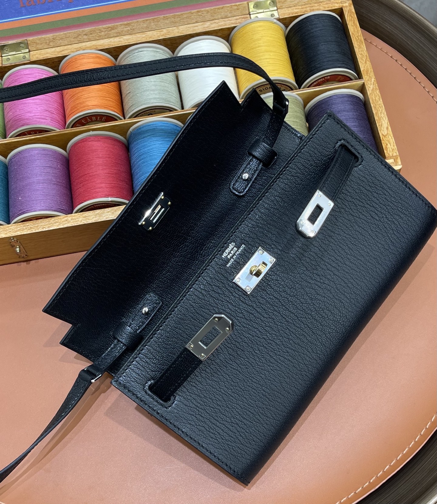 Hermès Model: Kelly ToGo Color: Black with silver hardware Dimensions: 20cm x 11cm x 2cm