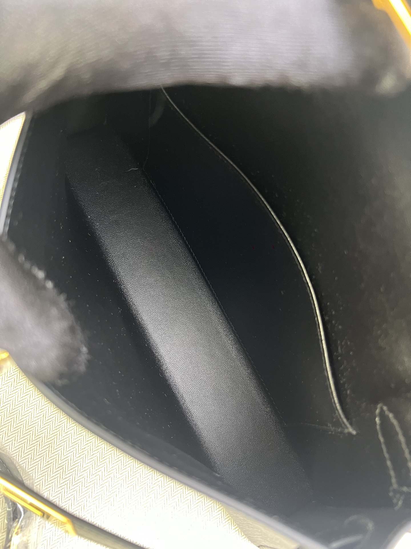 Hermès Model: Kelly Elan Color: Black with gold hardware Dimensions: 27.5cm x 15cm x 5cm