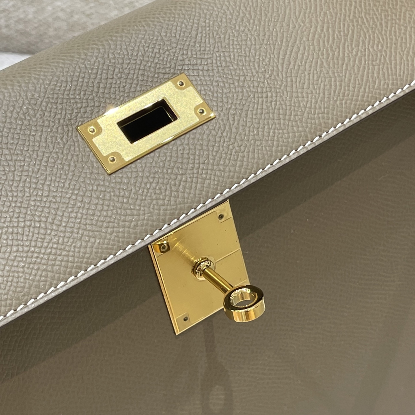 Hermès Model: Kelly 28 (Exterior Stitching) Color: Elephant Gray with Gold Hardware Dimensions: 28cm x 22cm x 10cm (including handles)