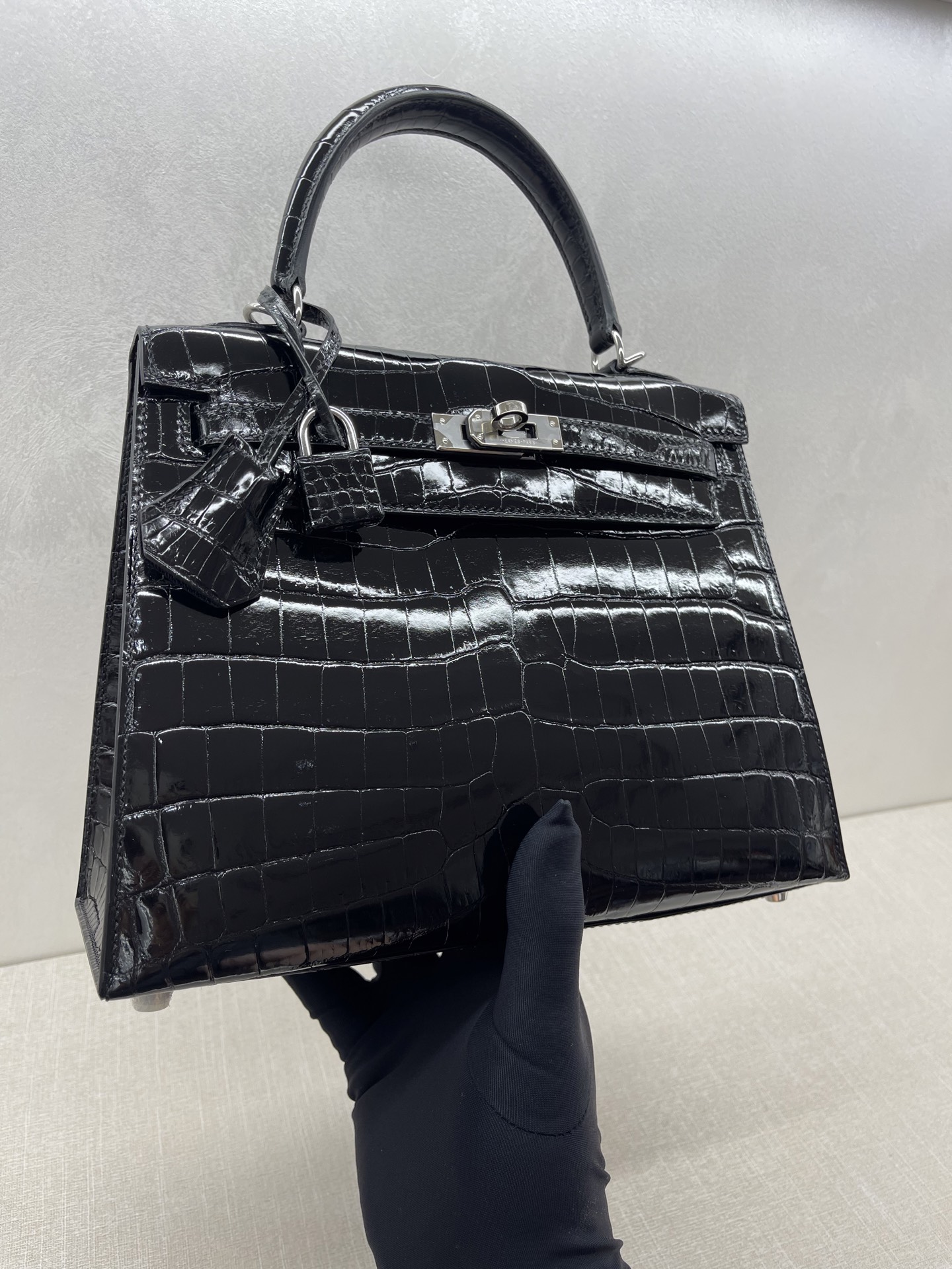 Hermès Model: Kelly 25 (Exterior Stitching) Color: Black with Silver Hardware Dimensions: 25cm x 9.5cm x 27cm (including handles)