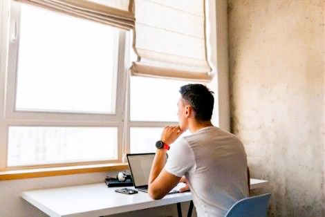 P E man looking out window