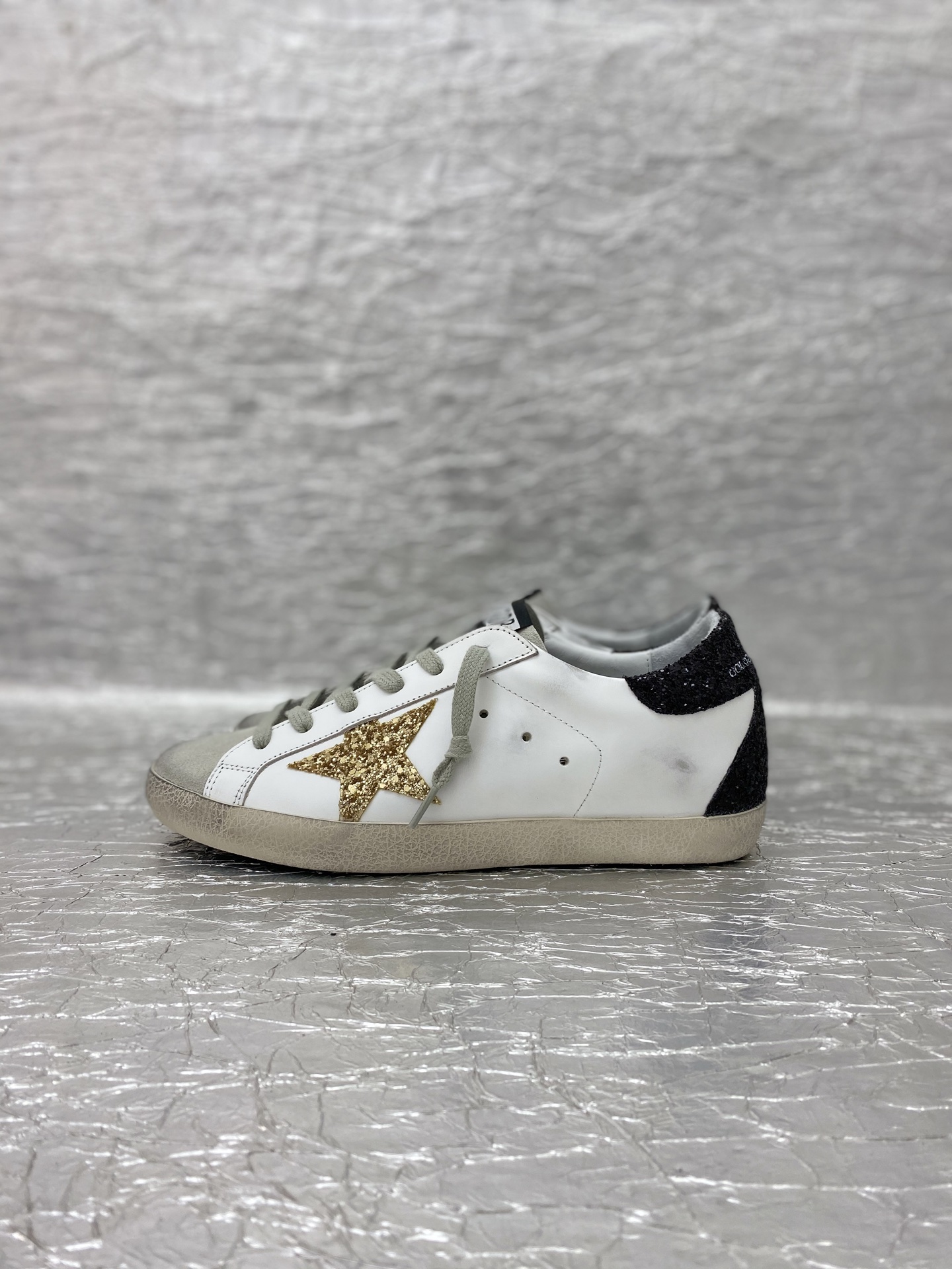 Golden Goose Super-Star in nappa leather with gold glitter star and black glitter heel tab