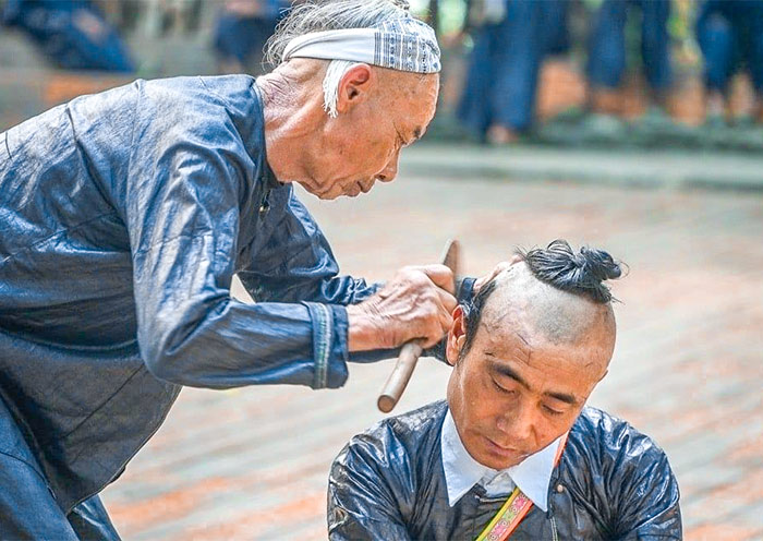 Basha Miao Village's sickle-based haircutting