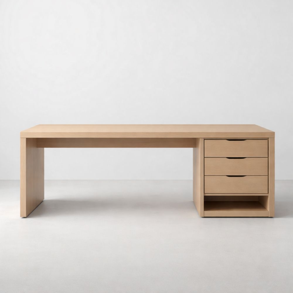 Light-colored wooden office desk with three drawers and a storage unit