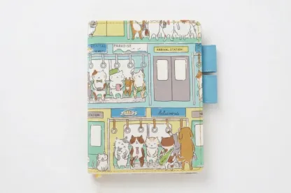 High-resolution product photo of a cat-themed fabric cover for Hobonichi planners on a seamless white background. Showcases the vivid colors of the tram illustration and premium stitching.