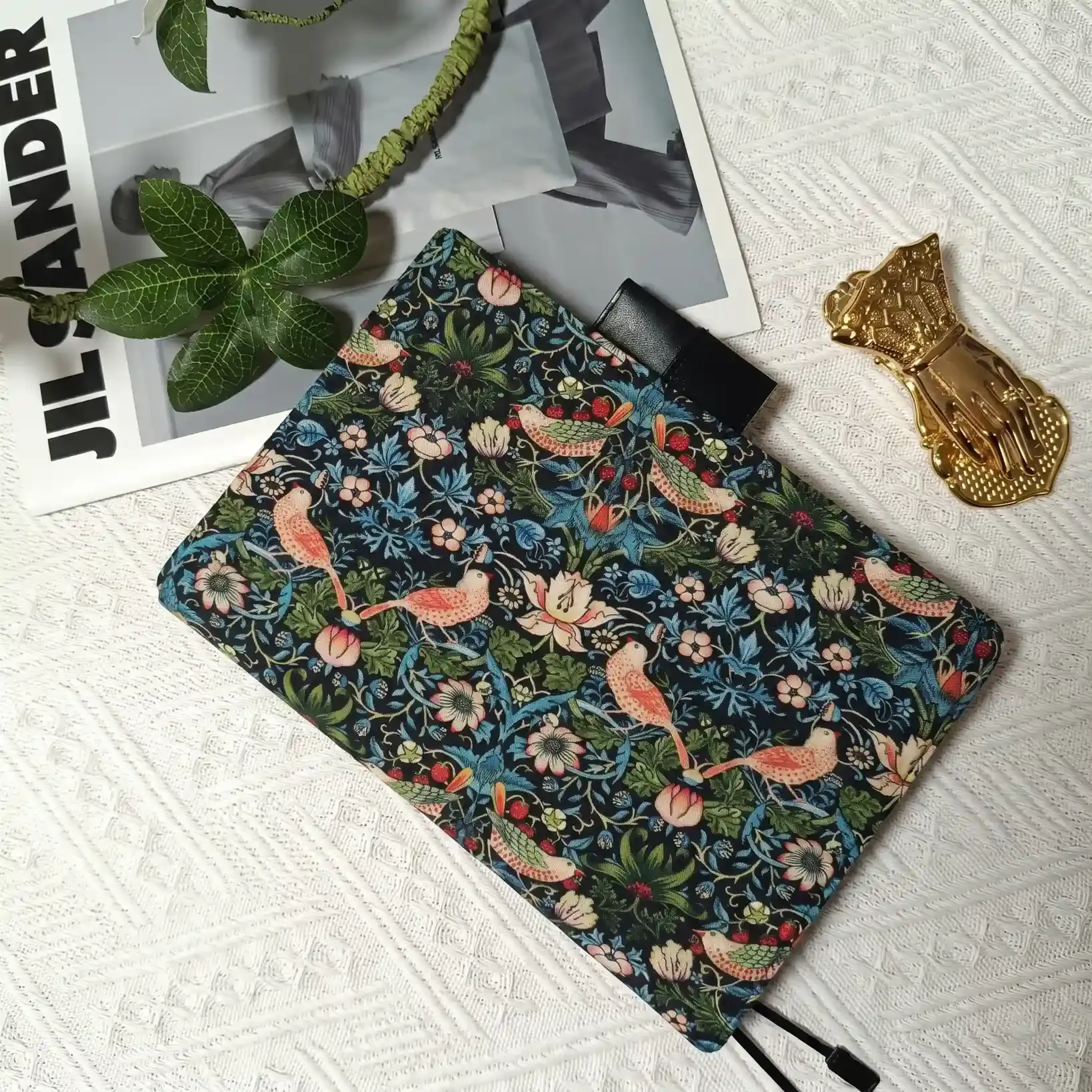 Aesthetic desk setup featuring a vintage-style floral cover styled for Hobonichi A5 on a lace background.