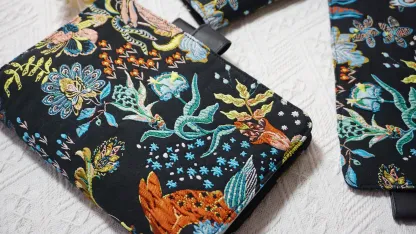 Close-up of colorful floral and rabbit embroidery on a black planner cover