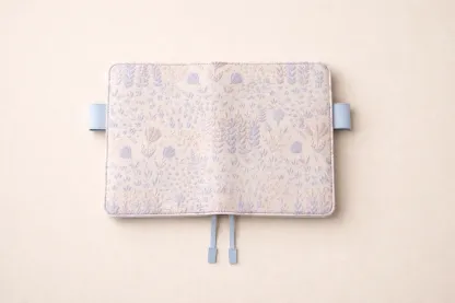 A fully spread view of a handmade floral embroidery journal cover by ABIGALECrafts, designed to fit Hobonichi A6 Techo planners.