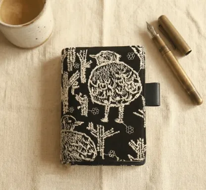 Detailed view of the spine and bookmarks of the ABIGALECrafts embroidered cover, compatible with Hobonichi Cousin and Day-Free