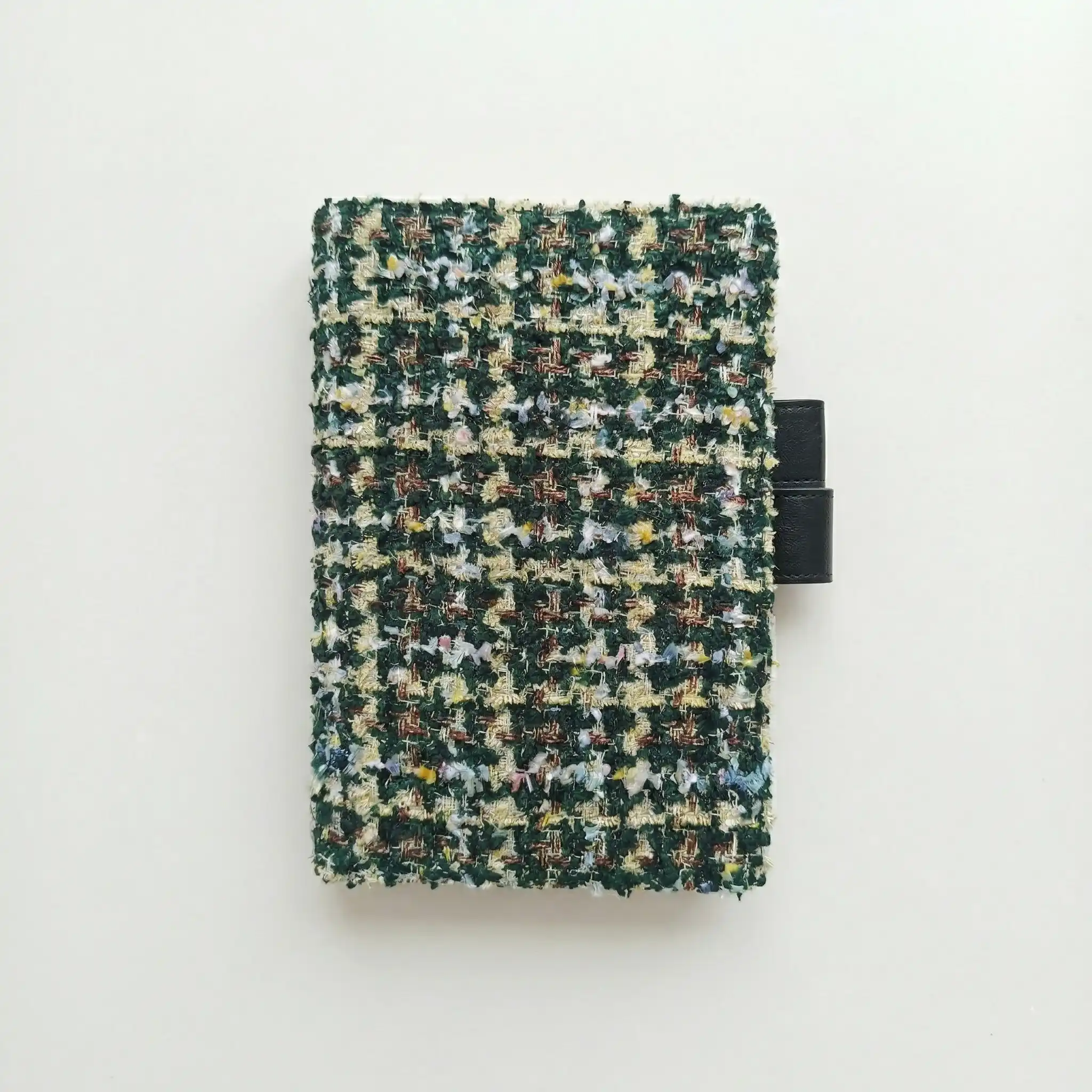 Green tweed fabric cover for Hobonichi Techo A5, minimalist white background.