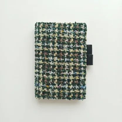 Green tweed fabric cover for Hobonichi Techo A5, minimalist white background.