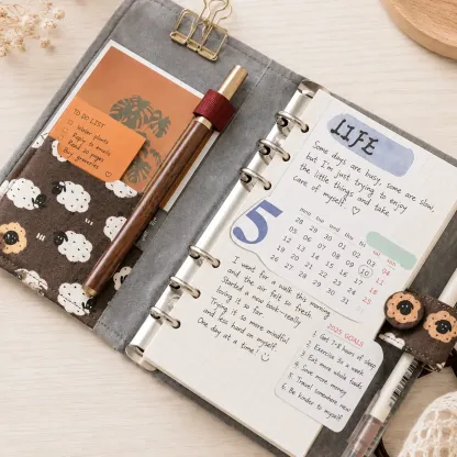 Open sheep print savings binder with pen pocket, planner inserts and 6-ring layout