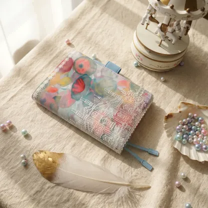 Angled view of pastel floral castle embroidered fabric cover for Hobonichi planner