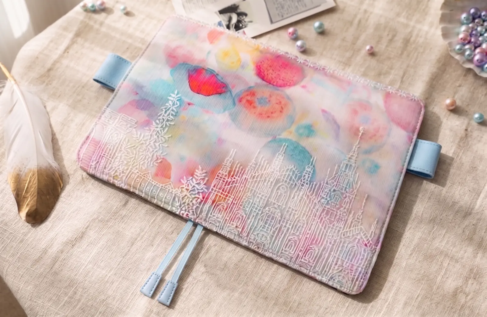 Pastel floral castle embroidered planner cover styled on a desk